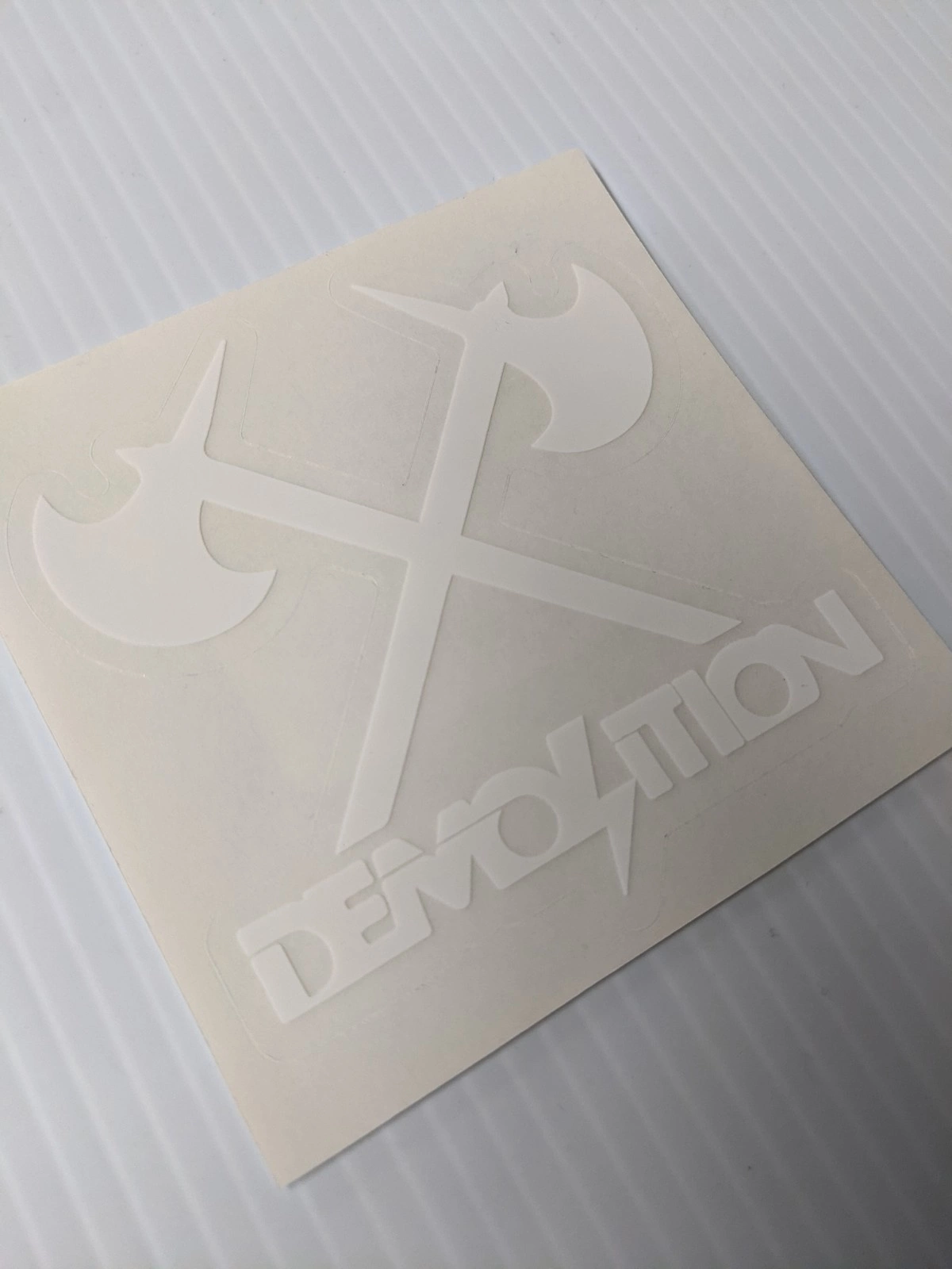 Demolition Sticker - Axes Logo - 3" x 3" - WHT Ea. 1 Demolition Sticker - Axes Logo - 3" x 3" - WHT Ea.